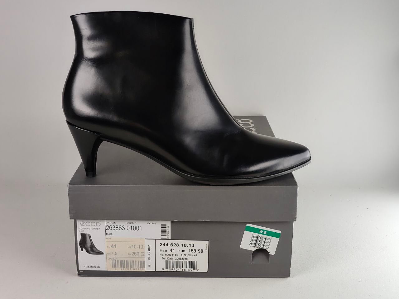 A black leather ankle boot with a kitten heel, displayed on top of its gray ECCO shoebox against a light gray background.