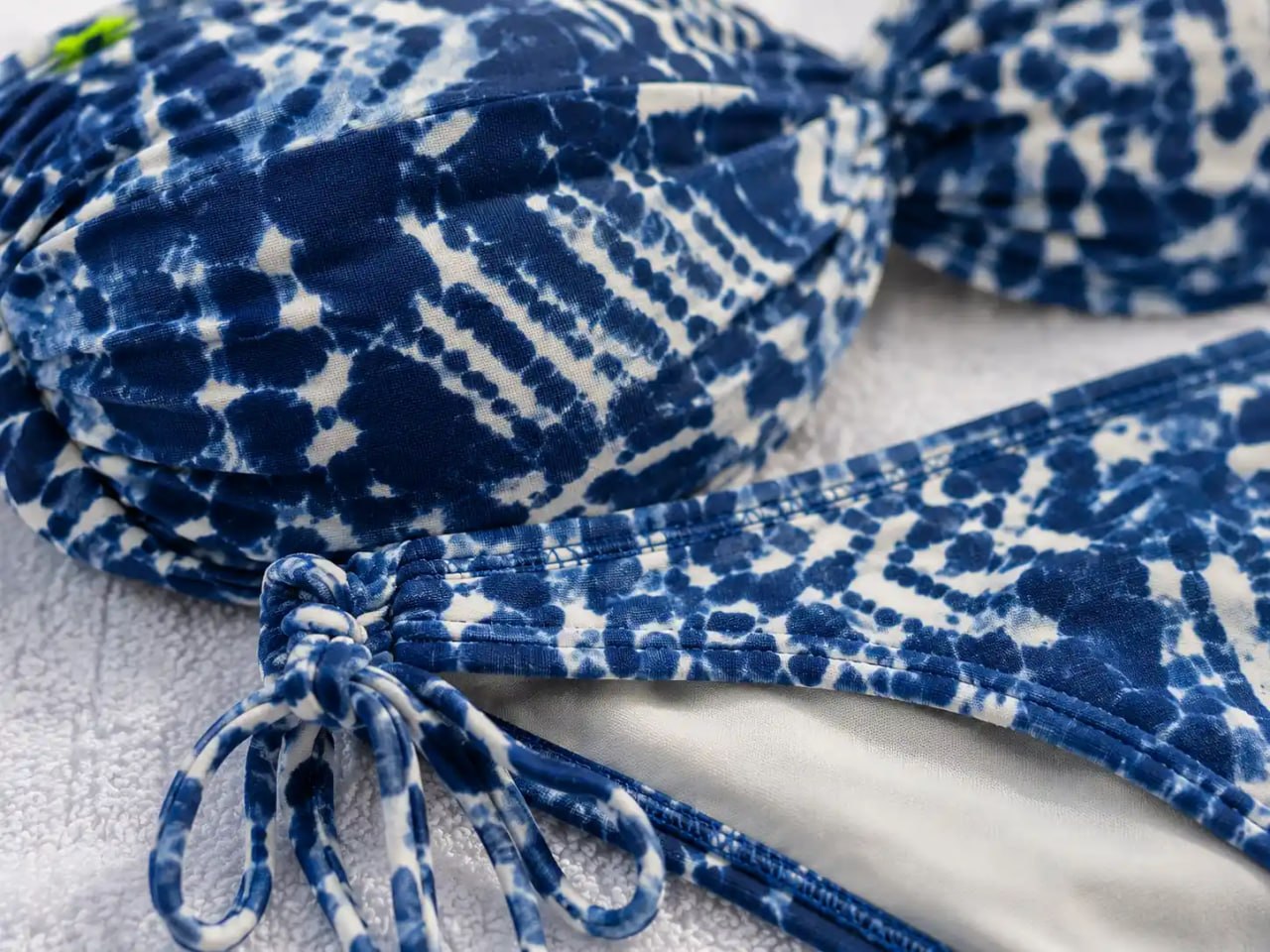 Blue and white patterned fabric with a knot on a light background