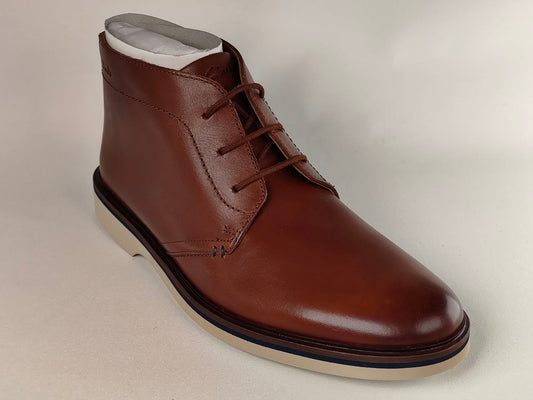 Brown leather shoe on a light gray background