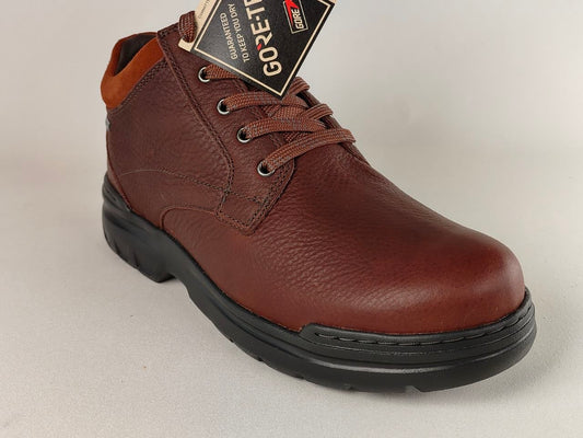 Brown leather shoe with a visible brand tag on a light gray background
