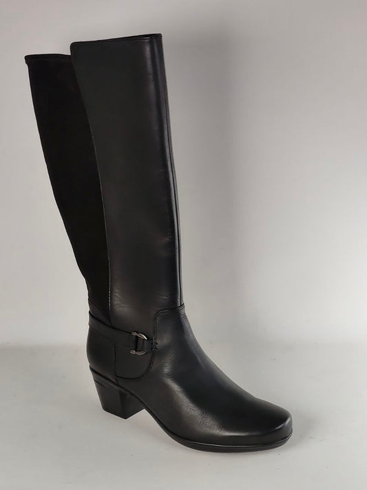 A single black knee-high leather boot with a low block heel and a decorative side buckle strap, photographed against a neutral light gray background.
