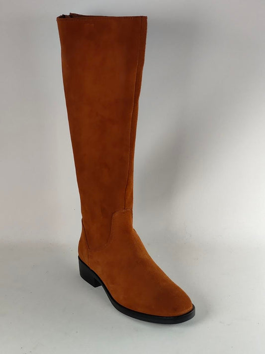 A single knee-high suede boot in a warm camel brown color, featuring a low black block heel and a black outsole, photographed against a neutral light gray background.