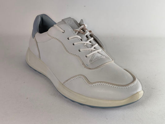 A white leather low-top sneaker with white laces, a light gray heel tab, and a cream-colored sole, shown on a neutral light gray background.