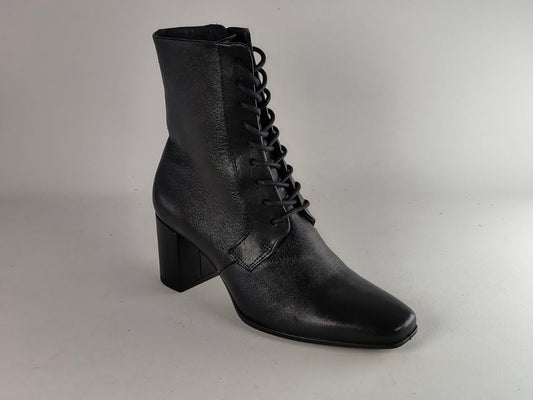 A black leather lace-up ankle boot with a block heel and pointed toe, photographed against a neutral light gray background.