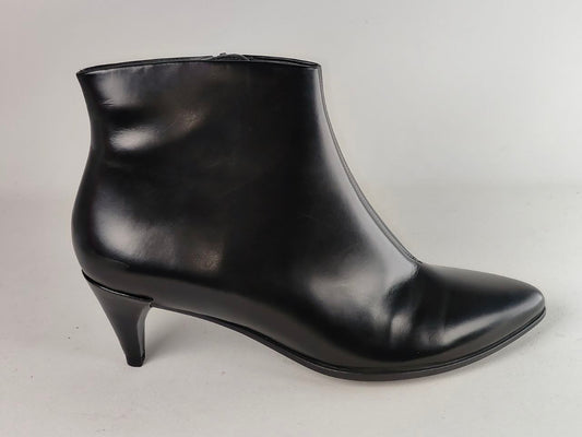A single black leather ankle boot with a pointed toe and a low kitten heel, photographed from the side against a neutral light gray background.