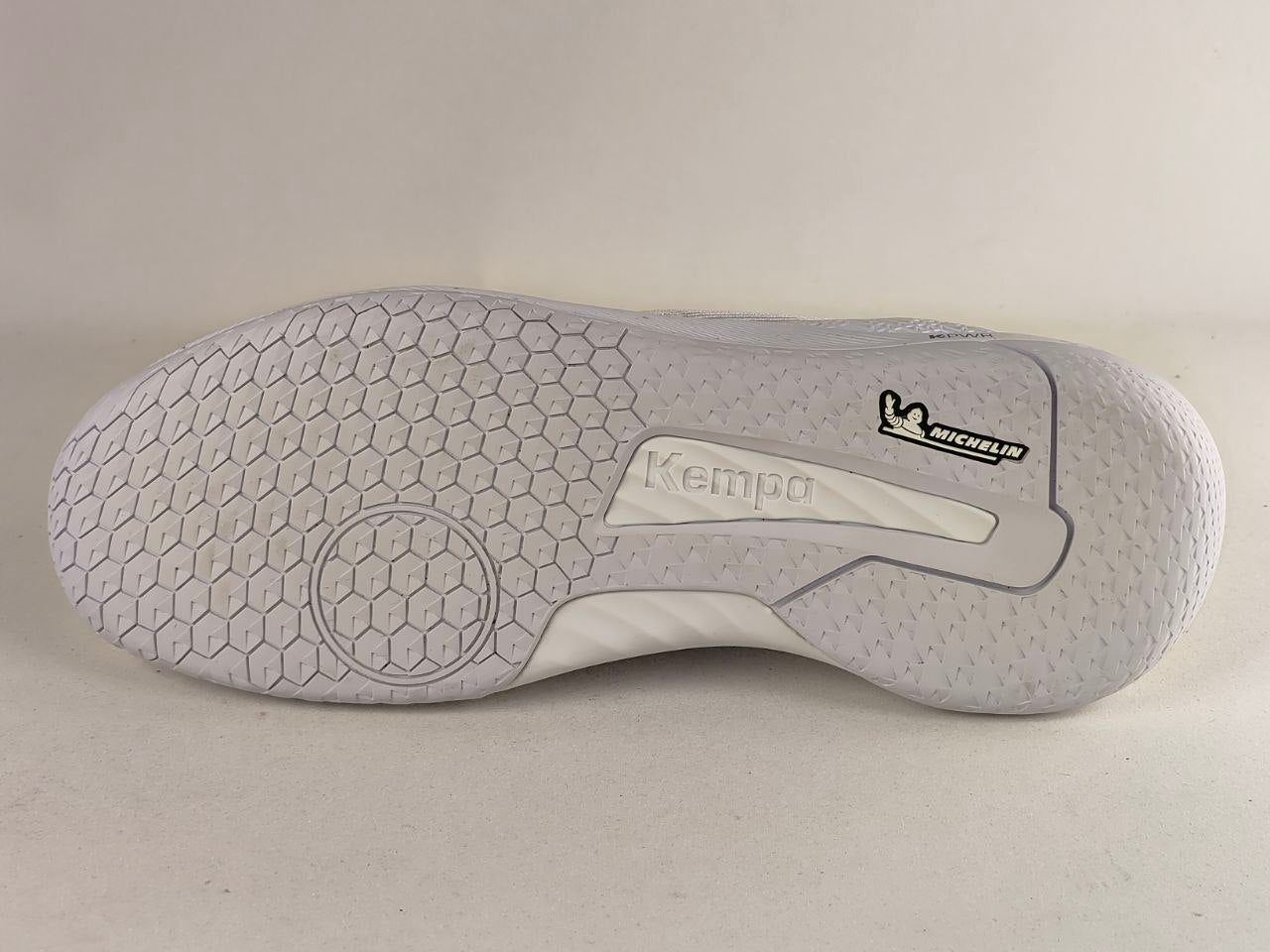 The outsole of a white and light gray athletic shoe, showing the Kempo logo and a Michelin brand mark on a neutral light gray background.