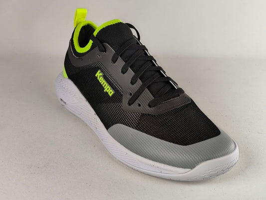 A black and gray athletic sneaker with neon yellow-green accents, featuring a white sole and the brand name 'Kemped' printed on the side, photographed on a light gray background.