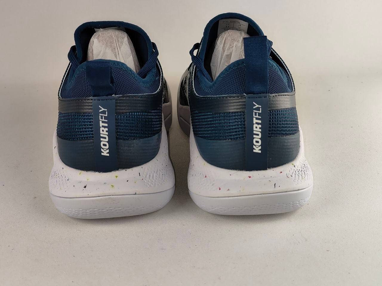 A pair of Kourtly basketball shoes shown from the back, featuring a navy blue and gray mesh upper with a white speckled sole, set against a plain light gray background.