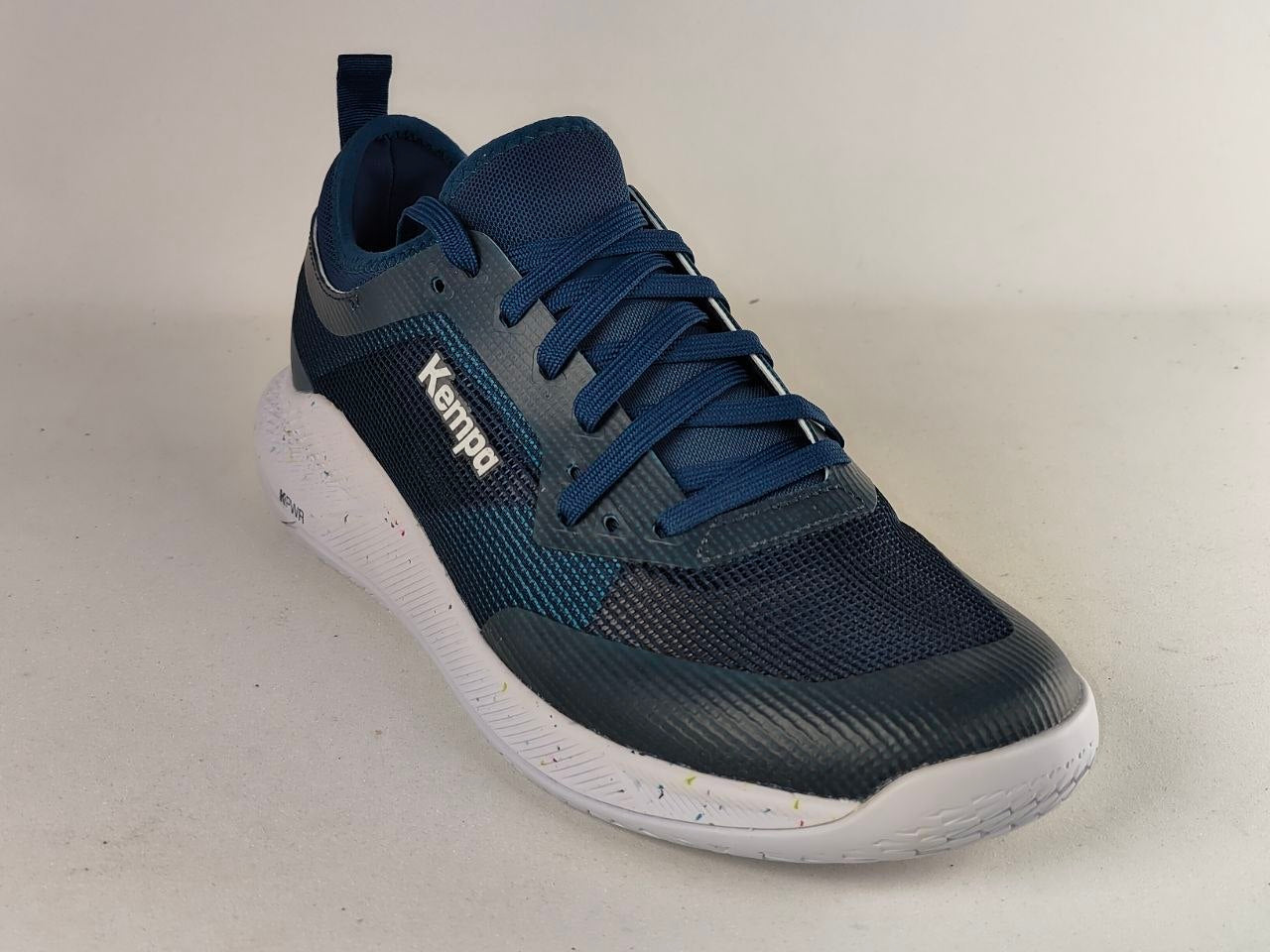 A single Kappa athletic sneaker in navy blue and dark gray with a white sole, photographed on a neutral light gray background.
