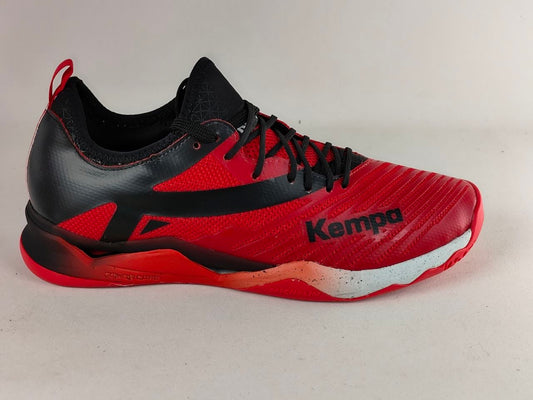 A red and black Kempa athletic shoe shown from the side against a light gray background.