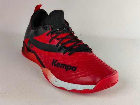 A red and black Kempa indoor court shoe shown from a three-quarters angle against a light gray background.