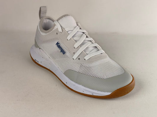 A white and light gray Kemper brand athletic shoe with white laces, a gray translucent toe bumper, and a brown outsole, photographed on a neutral beige background.
