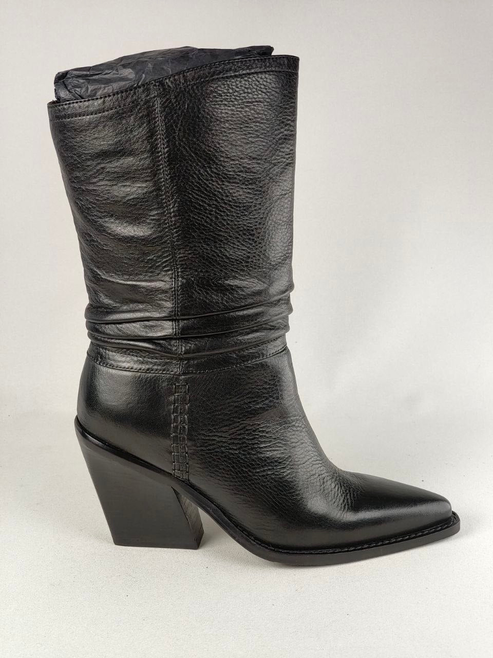 A black leather mid-calf boot with a pointed toe and a low block heel, shown from a side profile against a light gray background.