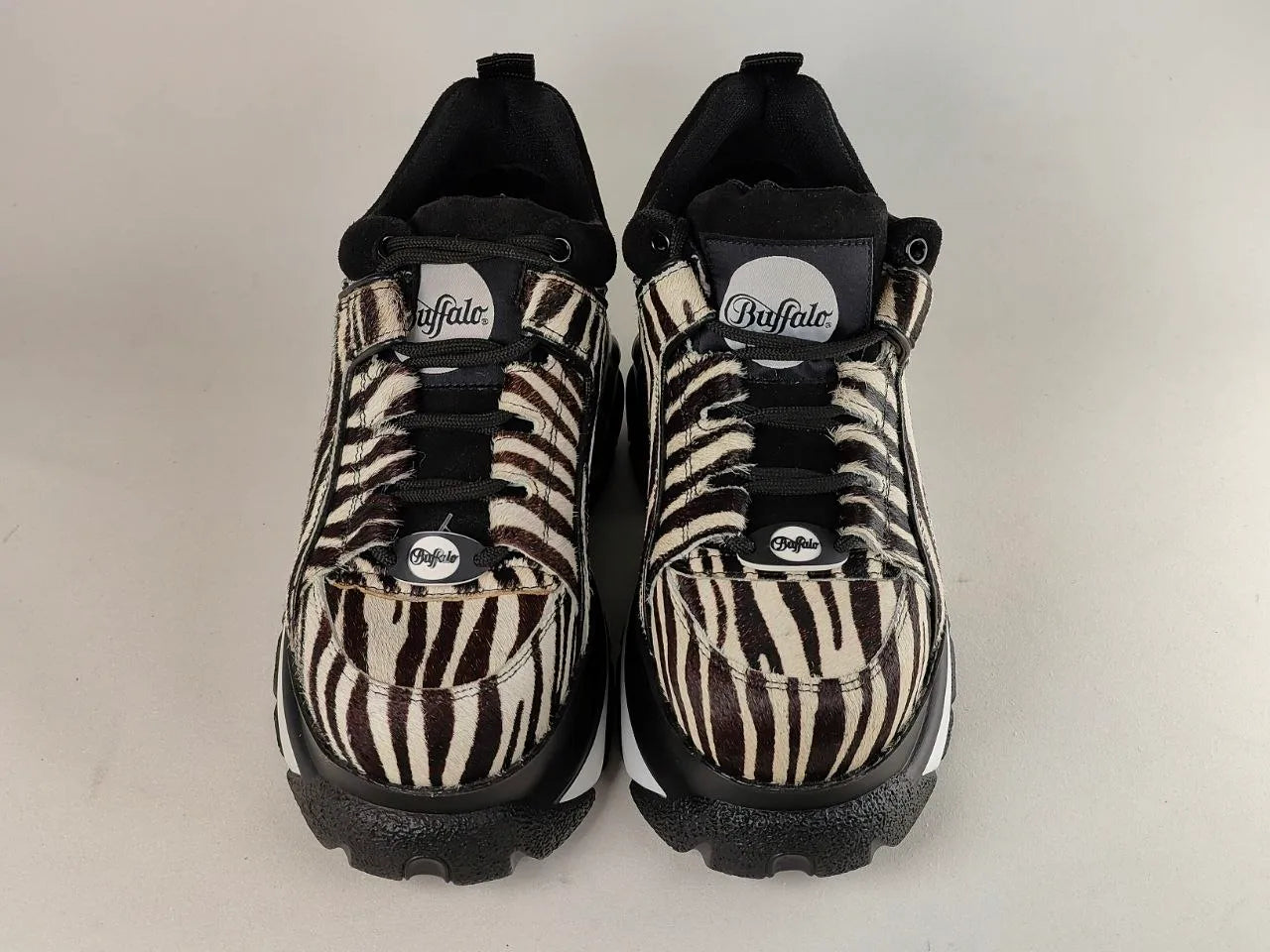 Pair of black and zebra-patterned Buffalo-London-1339 on a white background

