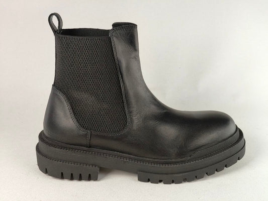 A black leather Chelsea-style ankle boot with a black elastic side panel and a chunky lug sole, shown from a side profile against a light gray background.