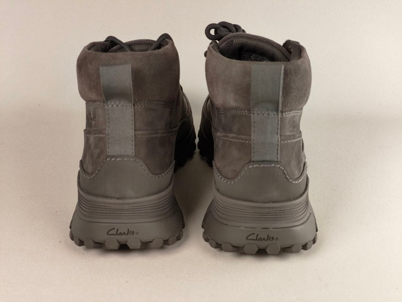 Rear view of Pair of Clarks ATL Trek Desert Grey Nubuck Outdoor Boots showing padded collar and heel support with 'Clarks' branding on a light background