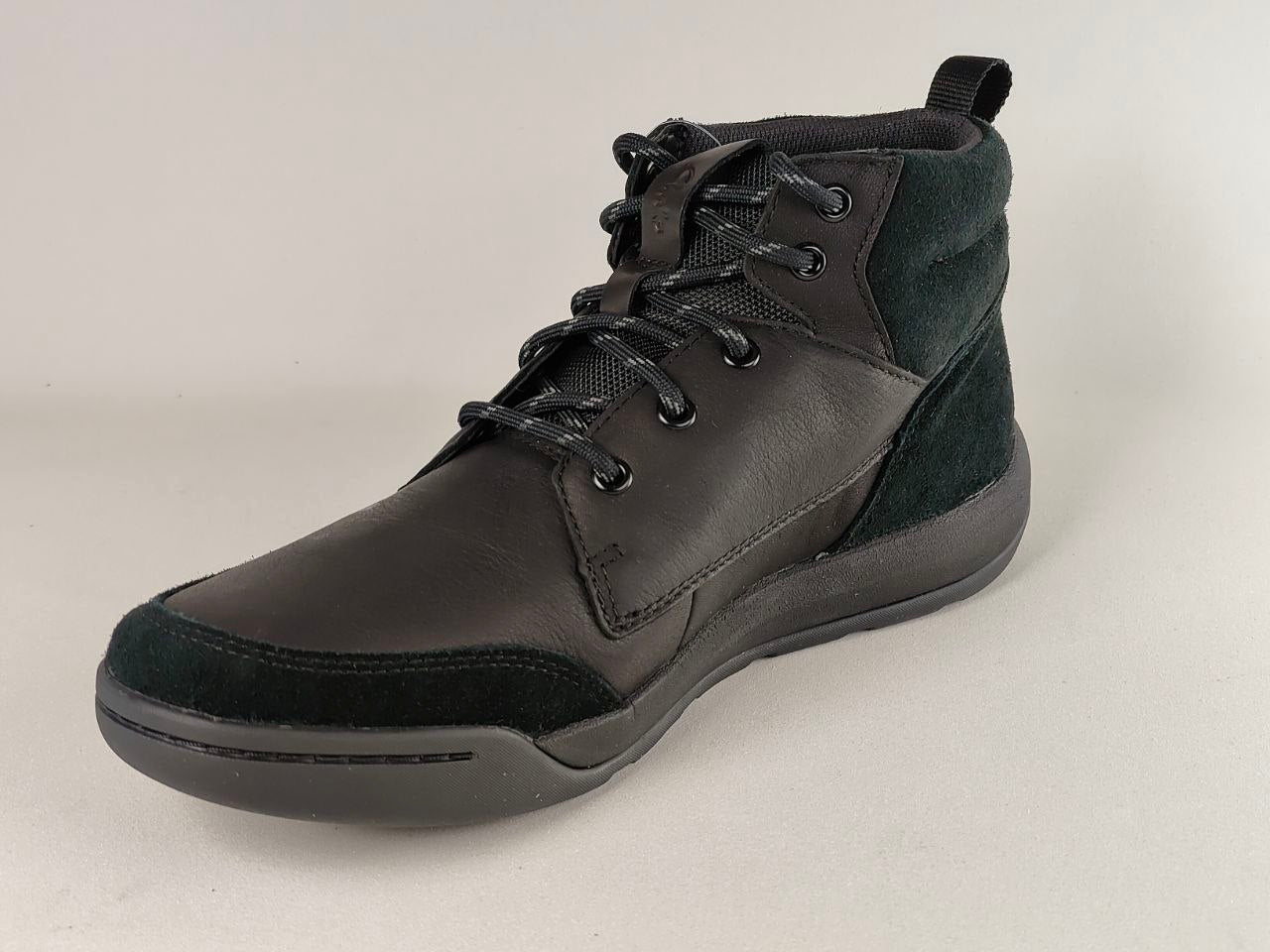 Black high-top sneaker on a light gray background