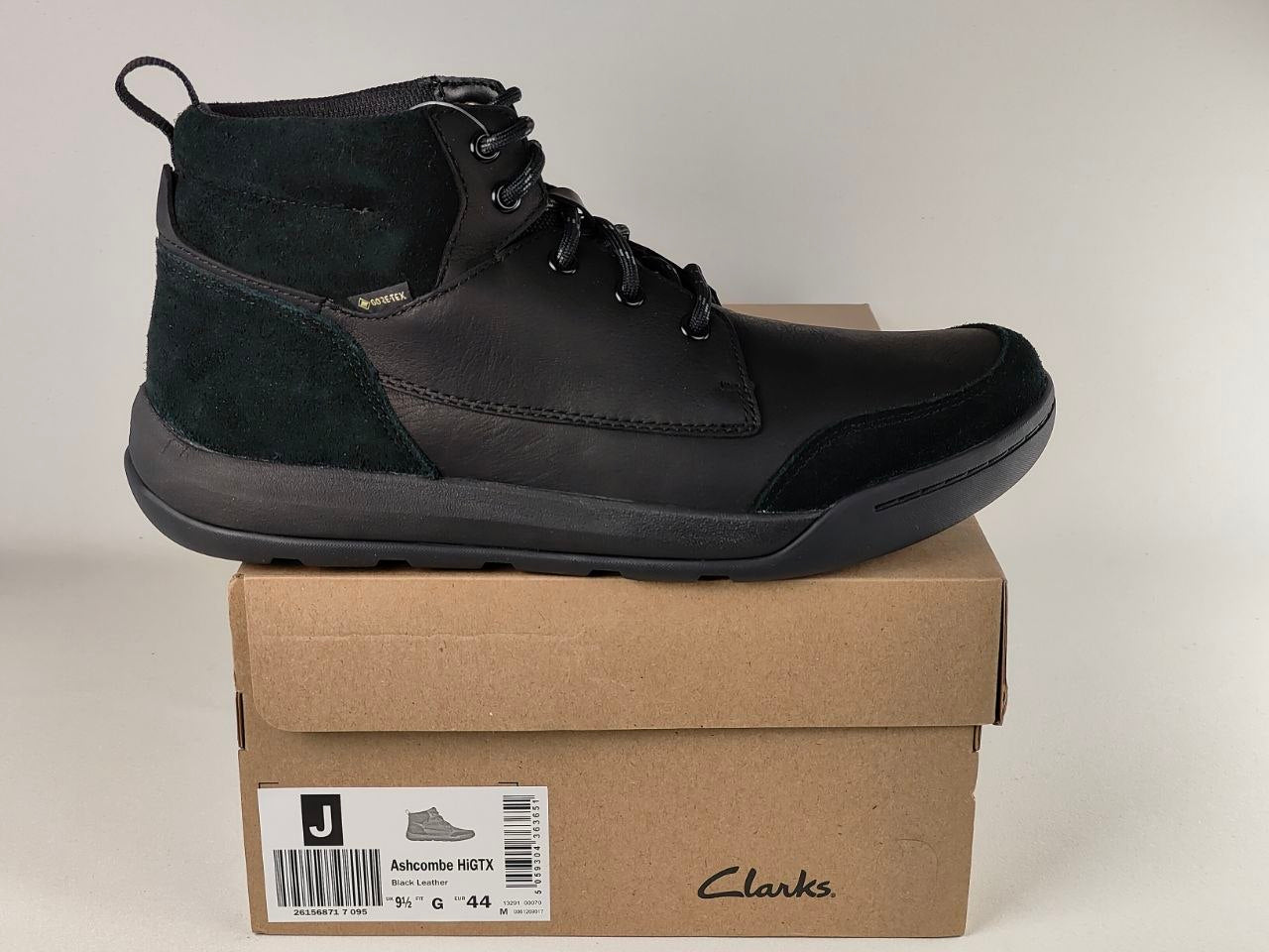 Black leather boot on a Clarks branded box with a neutral background