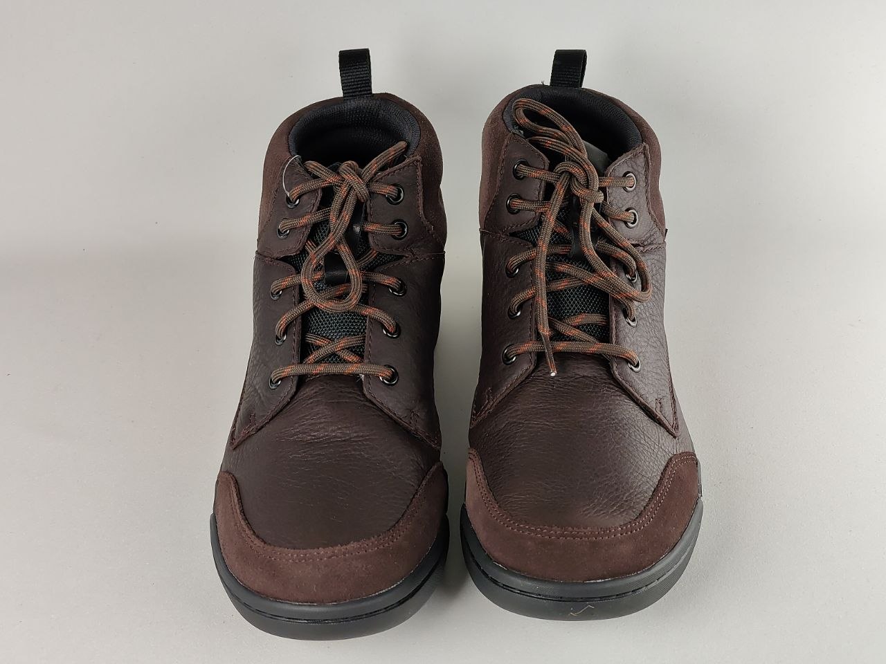 Pair of brown leather boots on a white background