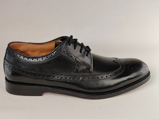 Black leather dress shoe on a light gray background