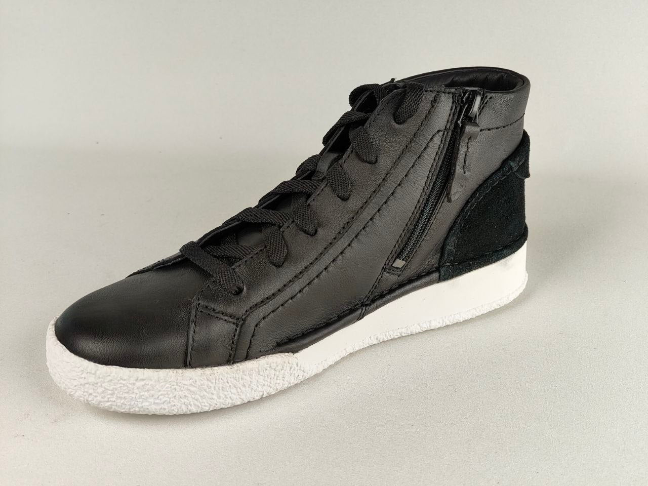 Black high-top sneaker with white sole on a light gray background