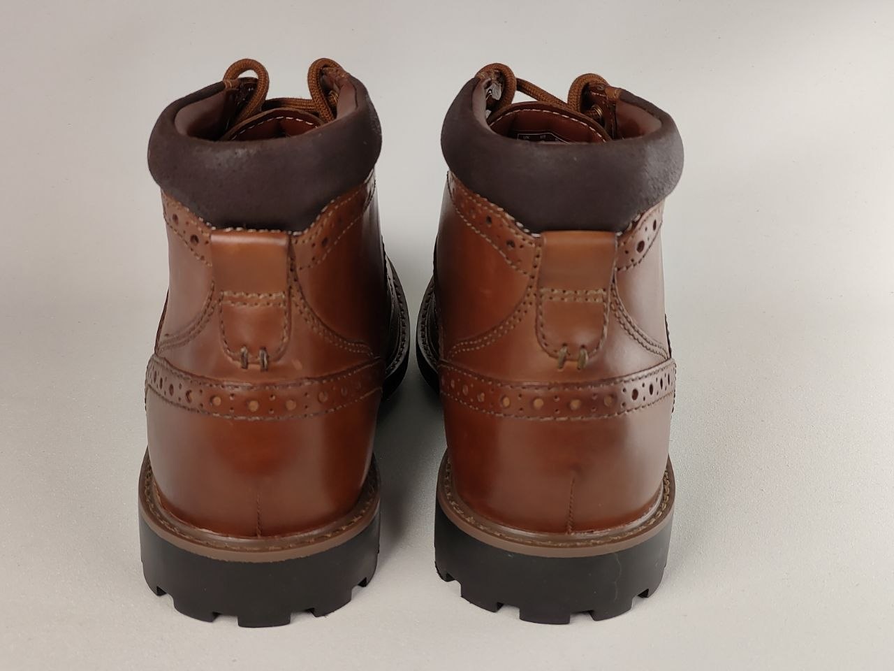 Pair of brown leather boots on a white background