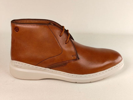 Brown leather boot with white sole on a beige background