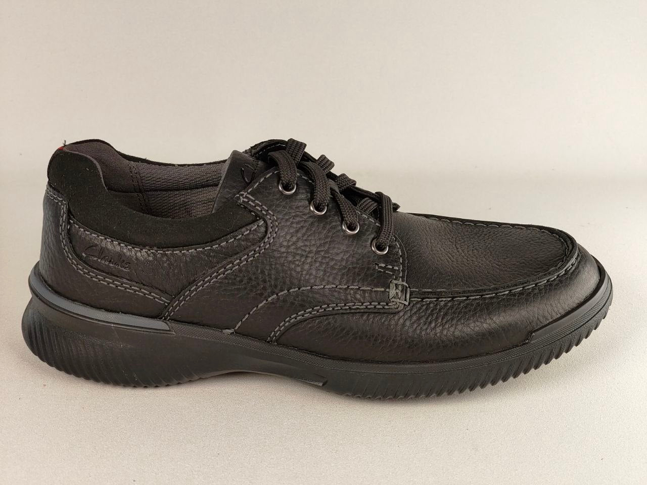 Black leather shoe on a light gray background