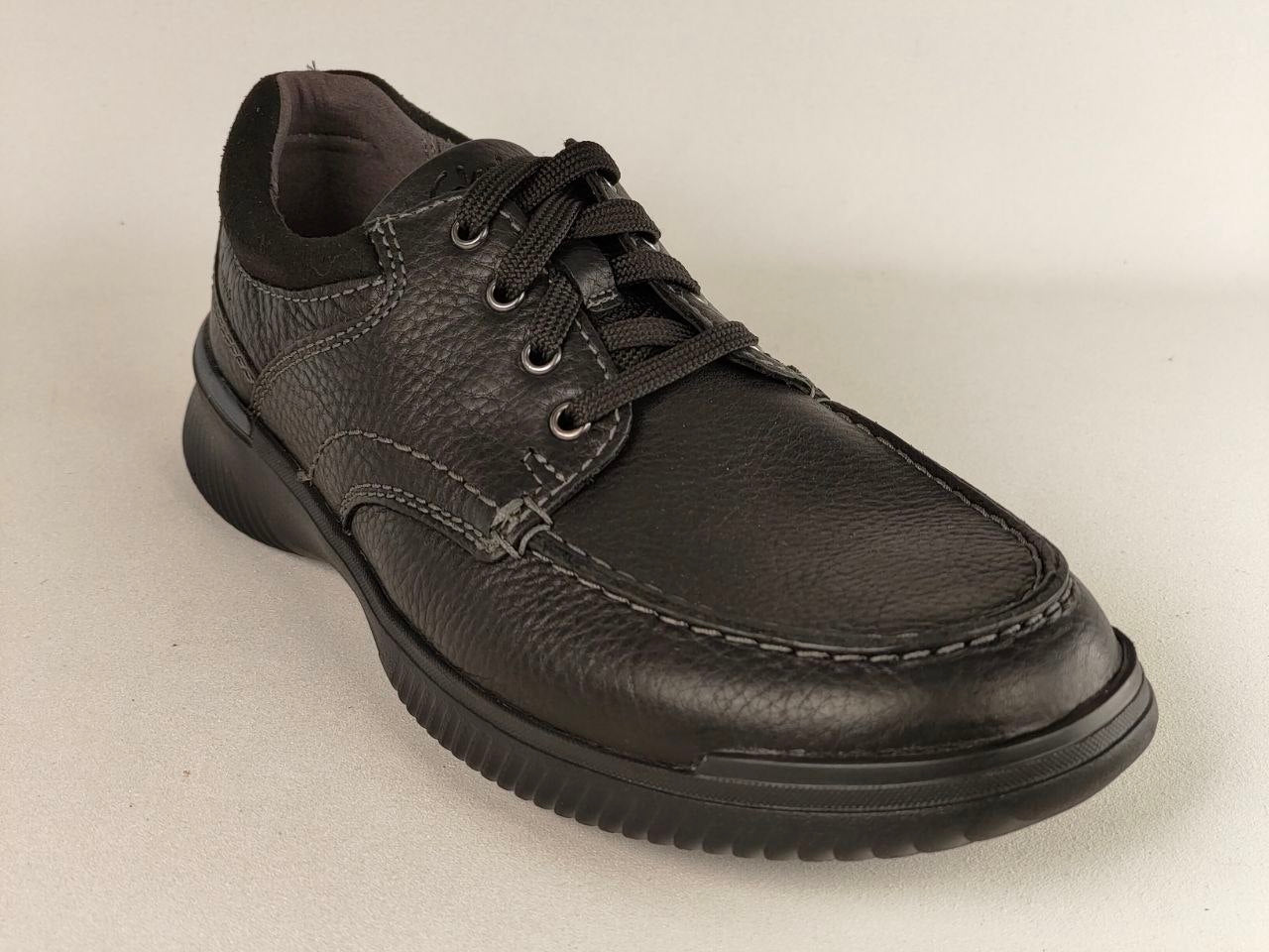 Black leather shoe on a light gray background