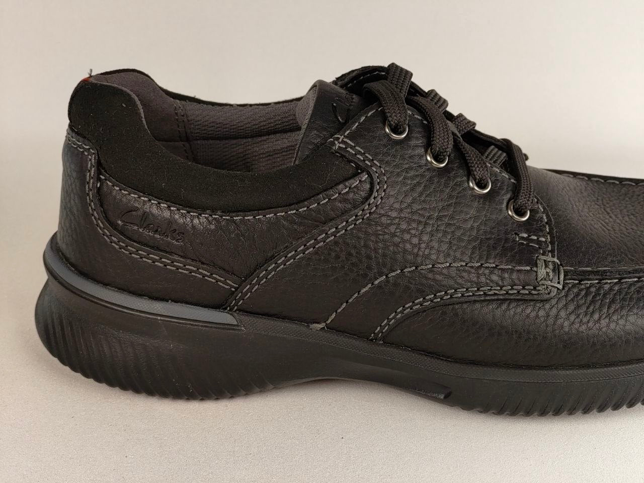 Black leather shoe on a light gray background