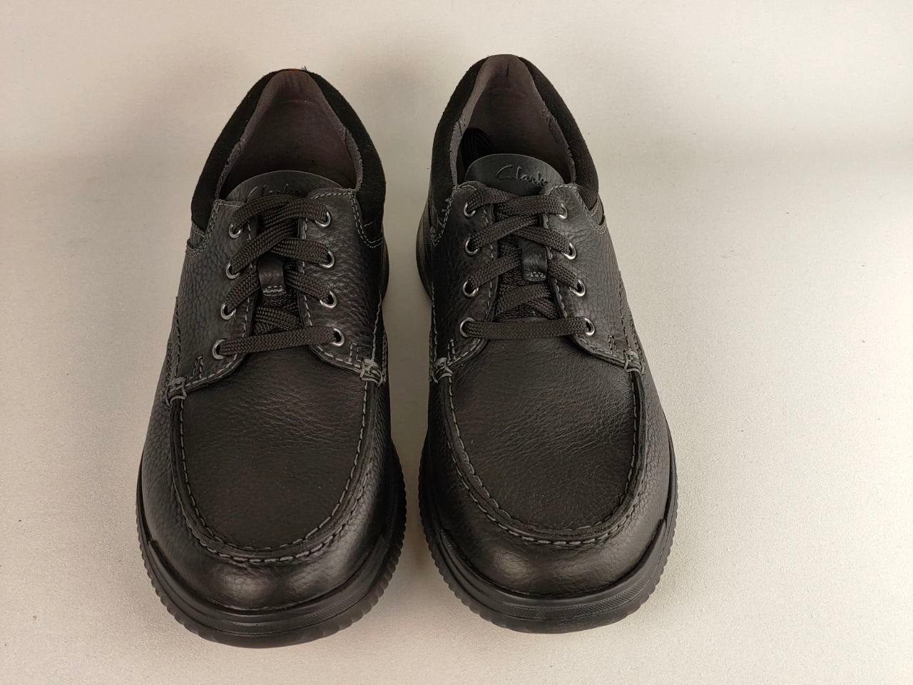 Pair of black leather shoes on a light gray background