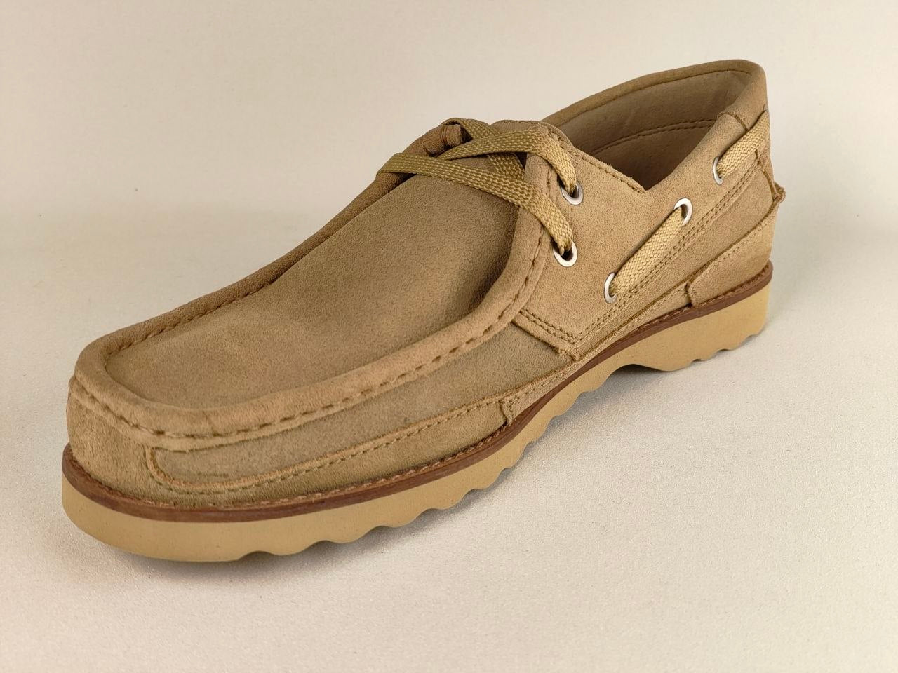 Beige leather shoe on a beige background
