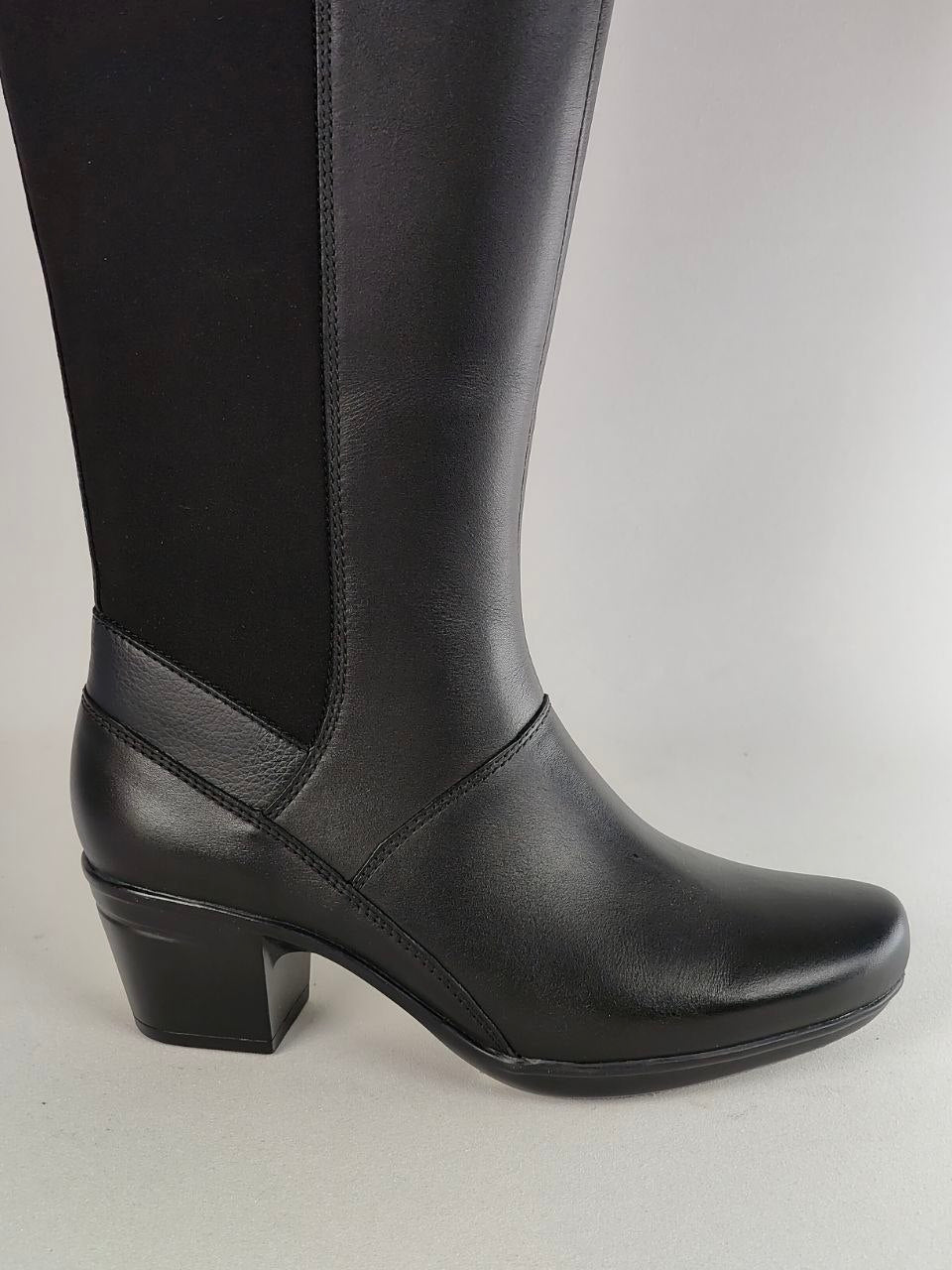 A black knee-high boot with a smooth leather-like finish and a black elastic side panel, shown in a side profile against a light gray background.