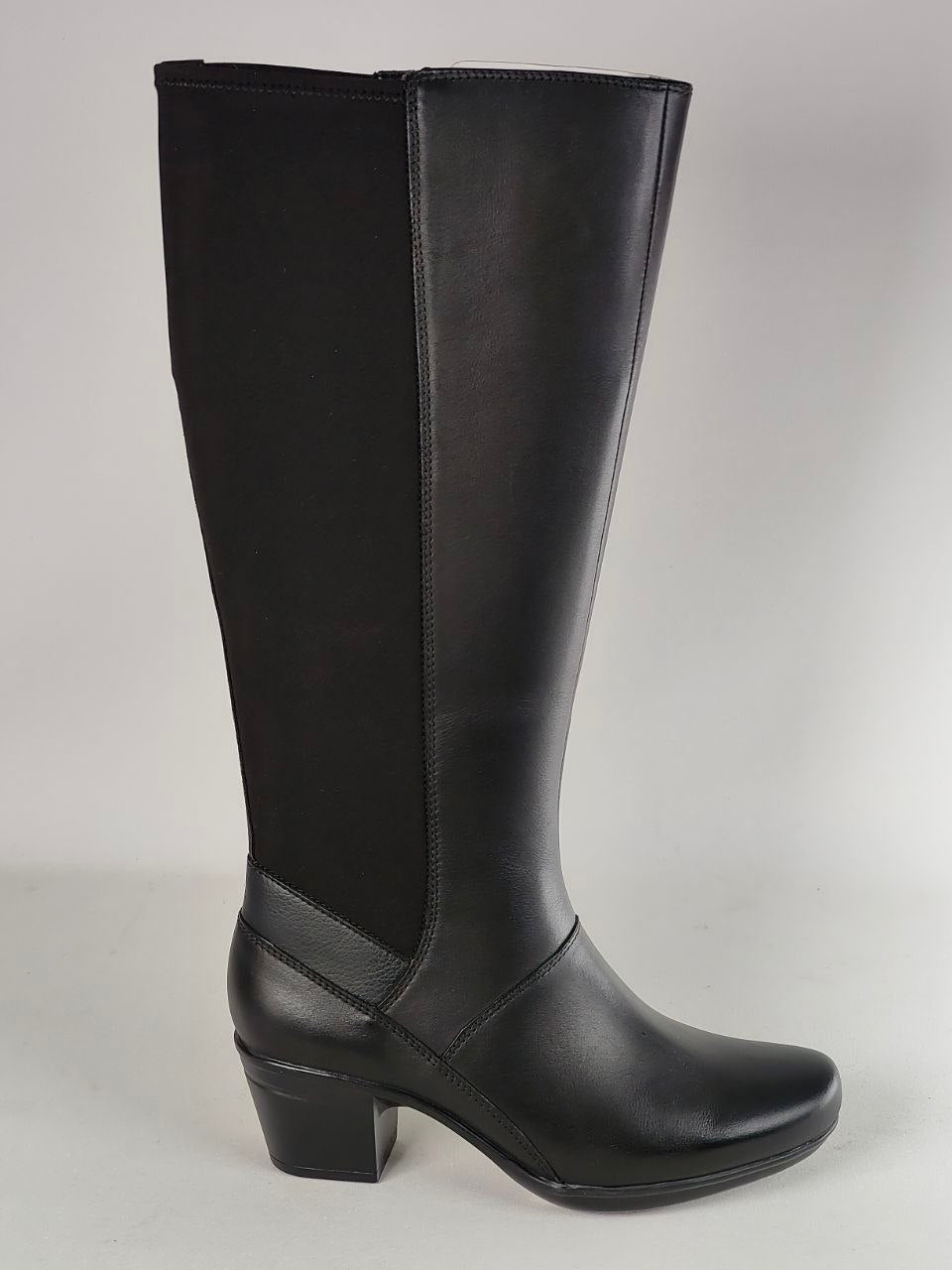 A single black knee-high boot with a smooth leather-like finish, black side panels, and a low block heel, photographed against a light gray studio background.