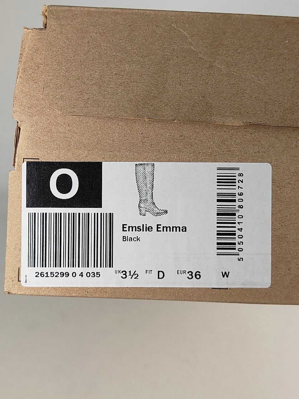 A brown cardboard shoebox with a white product label. The label shows a black boot illustration, the text 'Emslie Emma' and 'Black', a size '3 1/2', and barcodes.