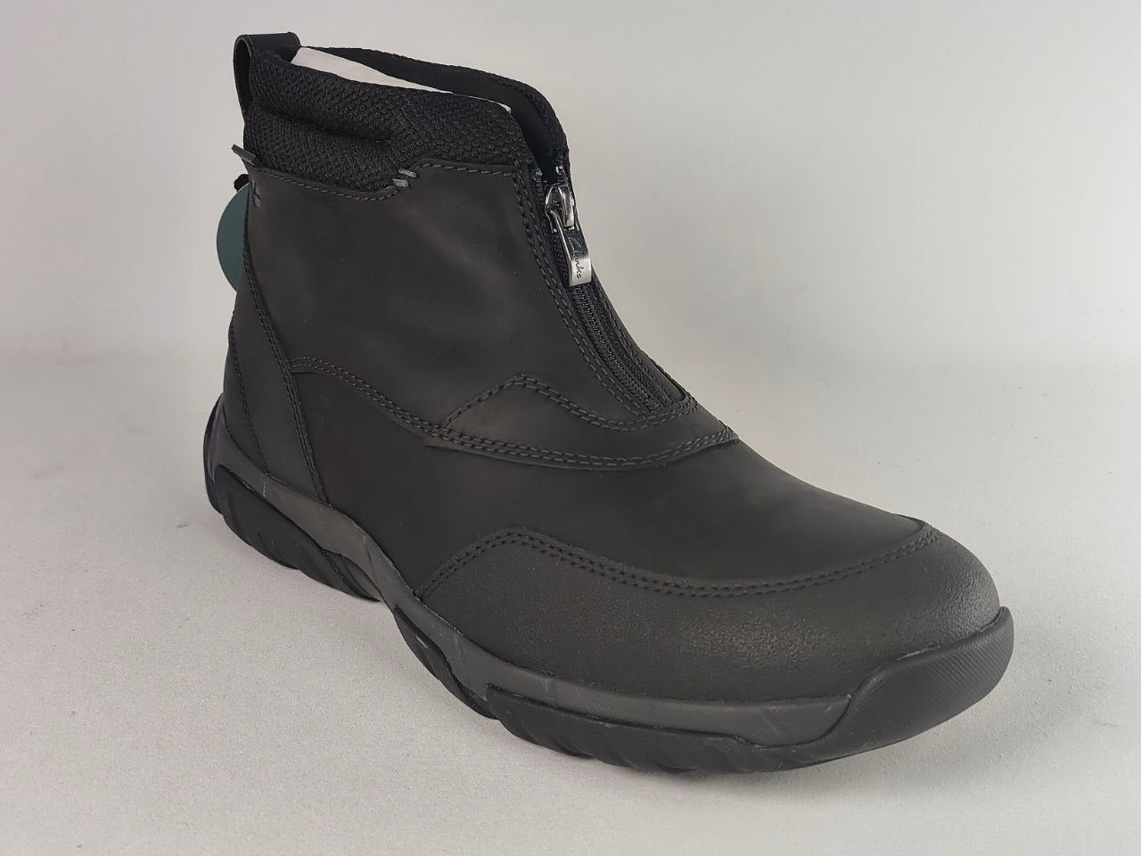A black ankle-height slip-on boot with a side zipper, shown on a light gray background.