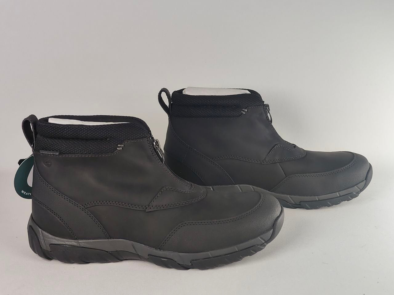 A pair of black ankle-height waterproof boots with a matte finish, shown from the side and back on a light gray background.