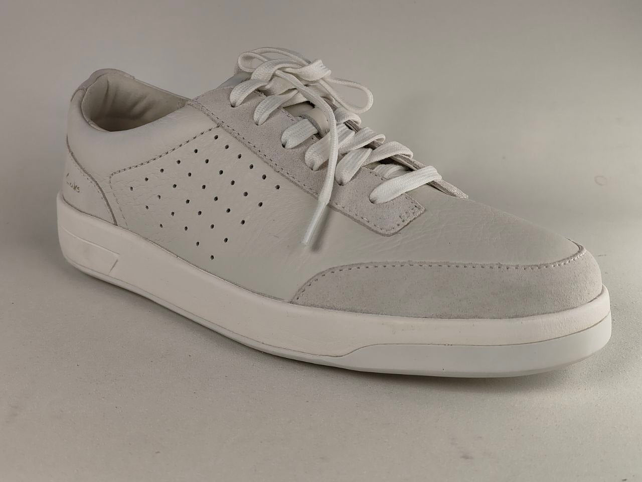 Gray sneaker with white sole on a gray background
