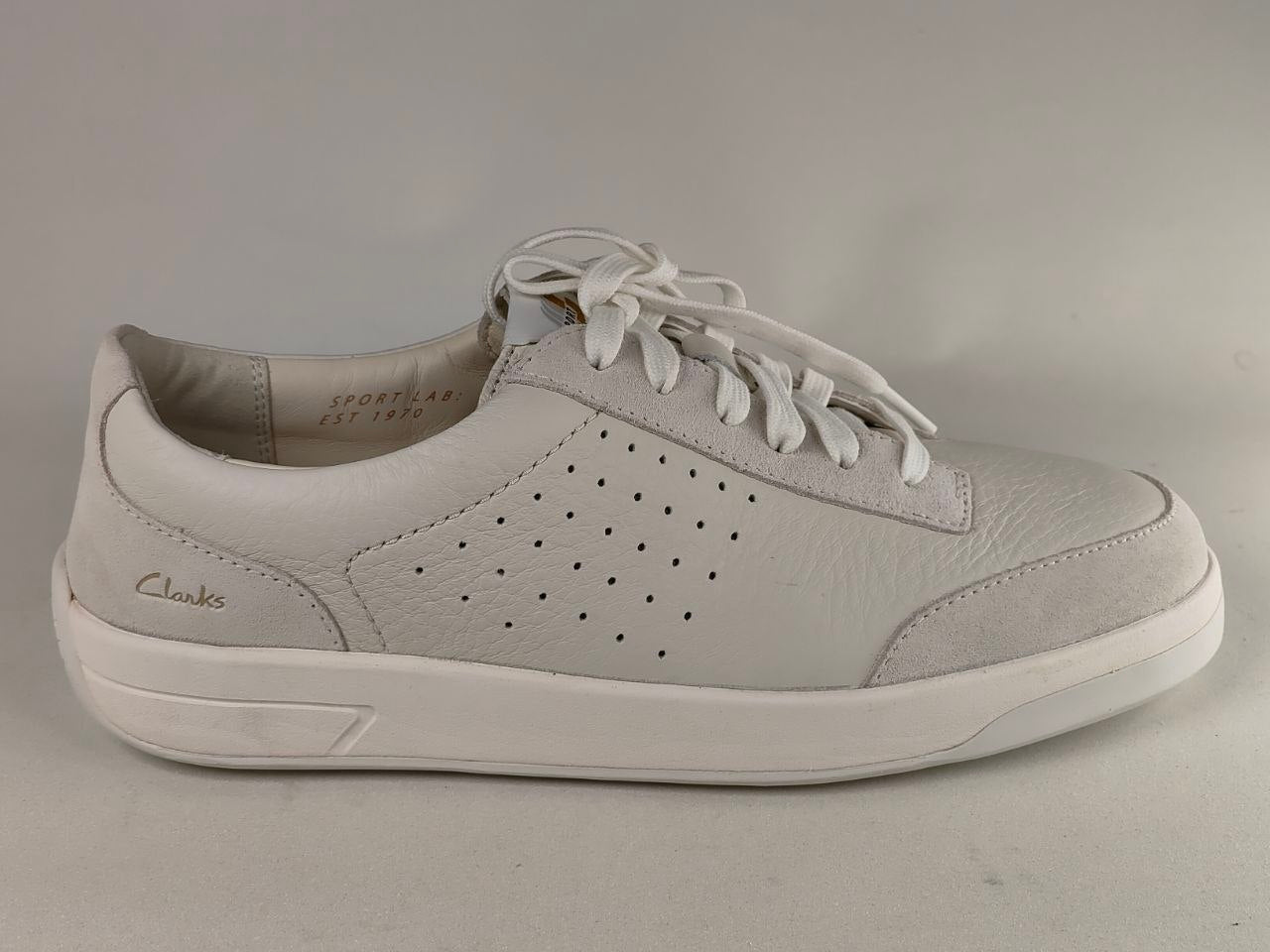 Gray sneaker with white laces on a gray background