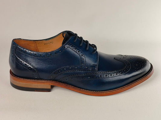 Blue leather dress shoe with brown sole on a light gray background
