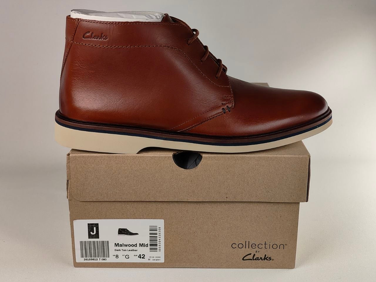Brown leather shoe on a Clarks box with a beige background