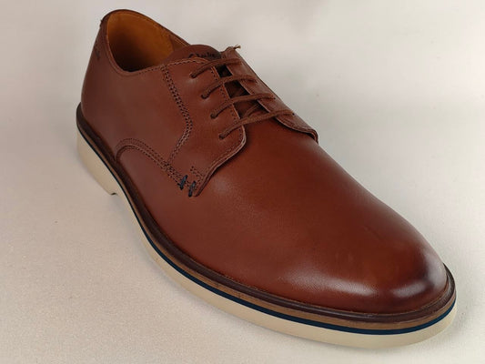 Brown leather shoe on a light beige background