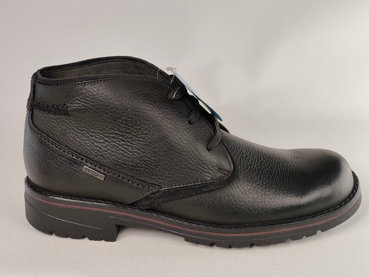 Black leather boot on a light gray background