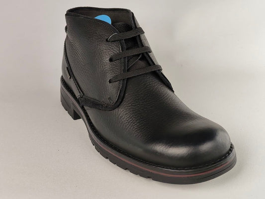 Black leather boot on a light gray background