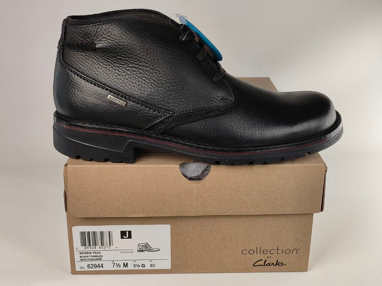 Black leather boot on a cardboard box with Clarks branding