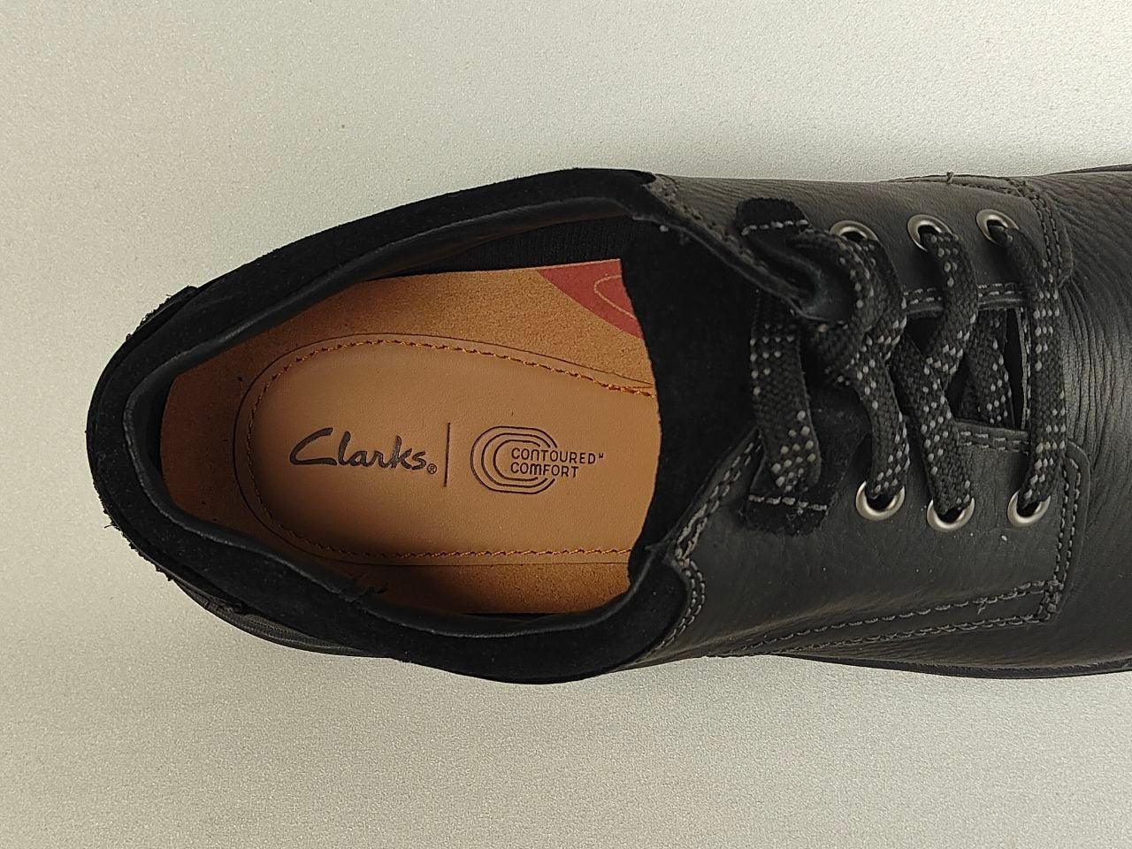 Black leather shoe with Clarks logo on a light gray background