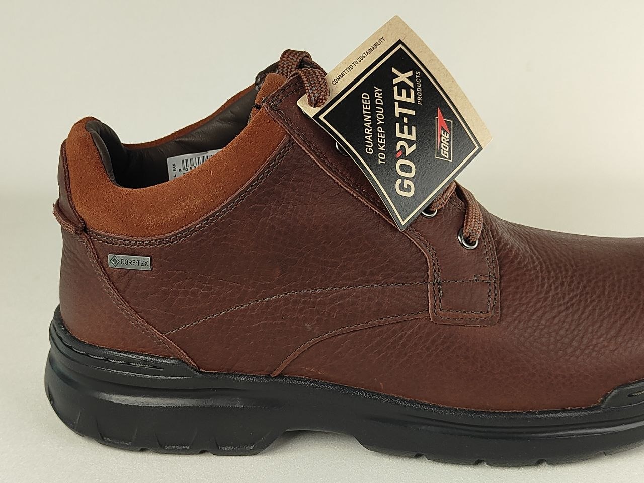 Brown leather shoe with GORE-TEX label on a white background