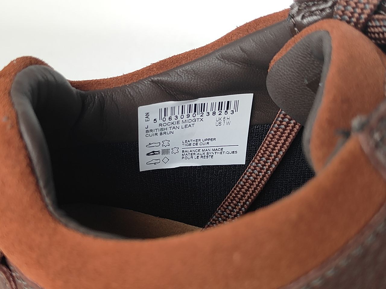 Close-up of a brown leather shoe's interior with a label.