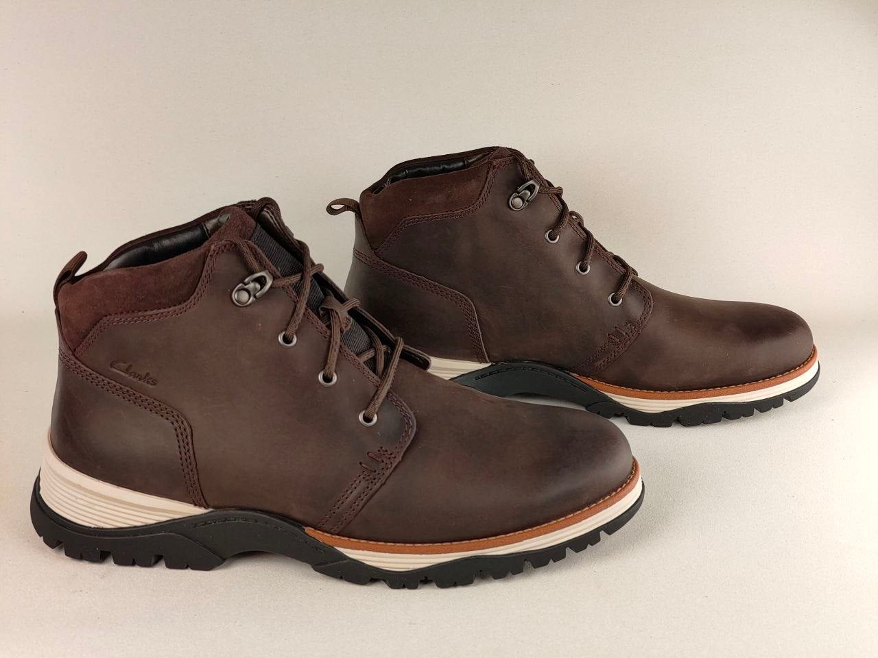 Pair of brown leather boots on a light gray background
