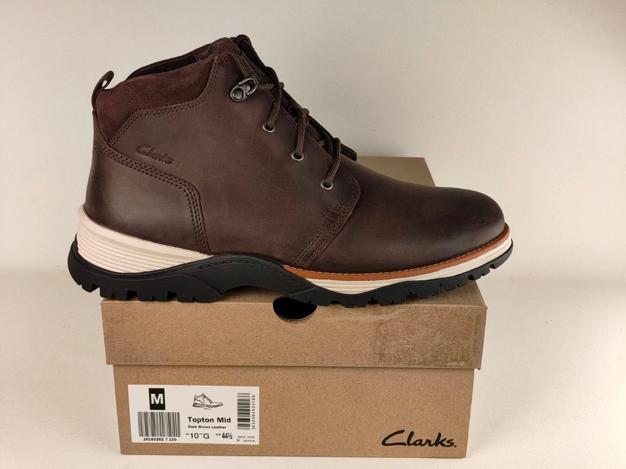 Brown leather boot on a Clarks box with a beige background
